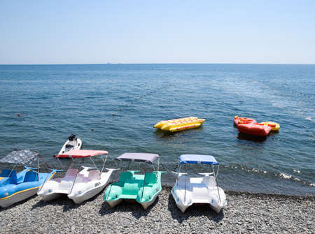 Novorossiysk, Russia - August 06, 2018: Catamarans and inflatable boats on the beach, on the dock. Novorossiysky beach wide beam.のeditorial素材