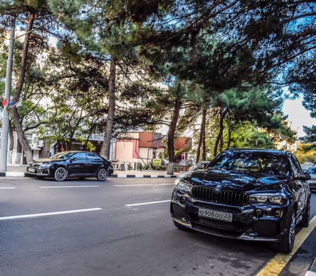 Novorossiysk, Russia - September 29, 2018: Car Toyota Camry and BMW X3 parked at the edge of the roadway.のeditorial素材