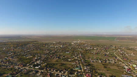 Top view of the village. The village of Poltavskaya. Top view of the village. One can see the roofs of the houses and gardens. Village bird's-eye view.の写真素材