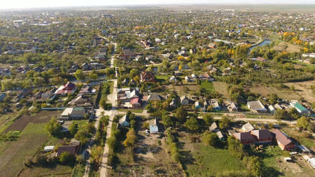 Top view of the village. The village of Poltavskaya. Top view of the village. One can see the roofs of the houses and gardens. Village bird's-eye view.の写真素材