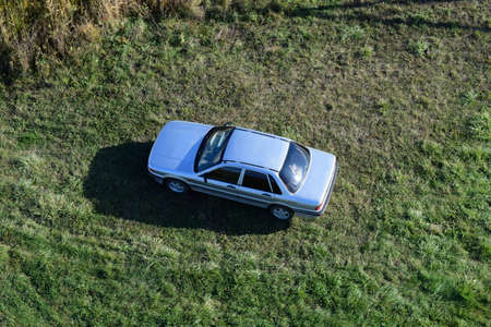 Top view of a silver car standing on the lawn. One Flew Over the Carの写真素材