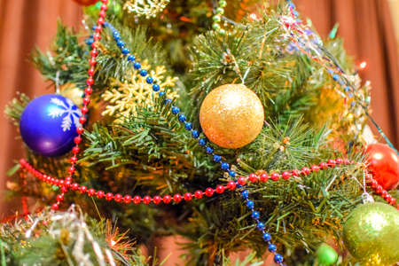 Tinsel and toys, balls and other decorations on the Christmas Christmas tree standing in the open air. Decorations New Year tree.の写真素材