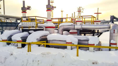 Node of valves on oil pipelines. Stop valves in the snow. Reducers on the valves