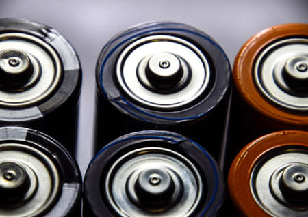 Salt and alkaline batteries, a source of energy for portable technology. AAA and AA batteriesの写真素材