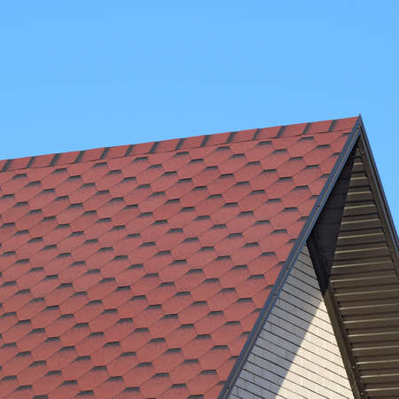Decorative metal tile on a roof. Types of a roof of roofs.