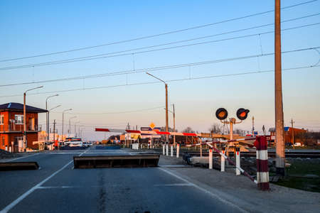 Krasnodar, Russia - March 31, 2018: Railroad crossing with a barrier and a traffic light.のeditorial素材