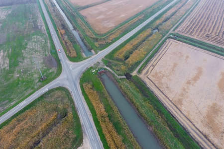 Crossroads paved roads through the fields. View from above.