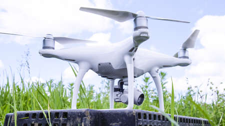 Quadrocopters on a plastic box in the grass. Preparation quadrocopter to fly.