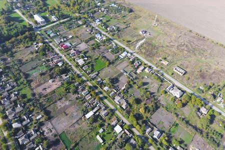 Top view of the village. One can see the roofs of the houses and gardens. Road the village. Village...