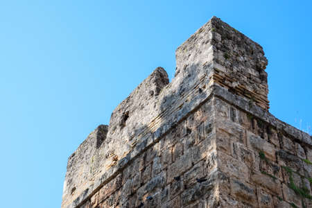 The wall near the gate of Hadrian, the texture of the stone walls of ancient stone blocks. Hadrians Gate, Antalya landmark. Ancient construction of the Gate of Hadrianの写真素材