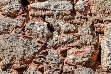 Background texture of an old masonry wall of limestone and cement.の写真素材