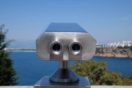 Inspection binoculars on the waterfront. Inspection of the Antalya embankment through the viewing...