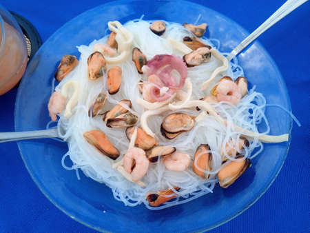 Seafood platter with mussels, shrimps, squids and octopus. Rice noodlesの写真素材