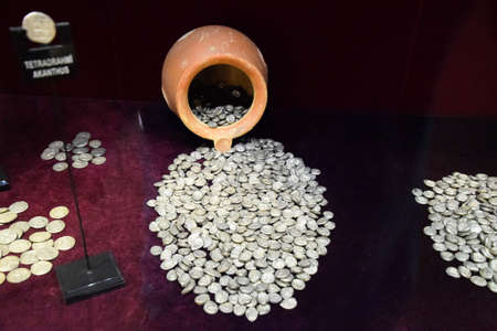 Antalya, Turkey - May 20, 2019: Silver coins poured out of a clay potのeditorial素材