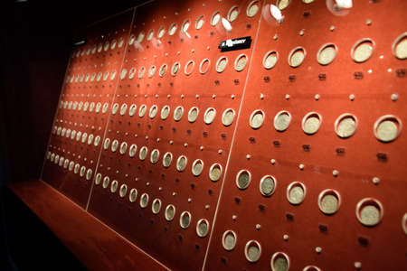 Antalya, Turkey - May 20, 2019: Coins at the Antalya Antiquities Museum. Old coins on the rack with light.のeditorial素材