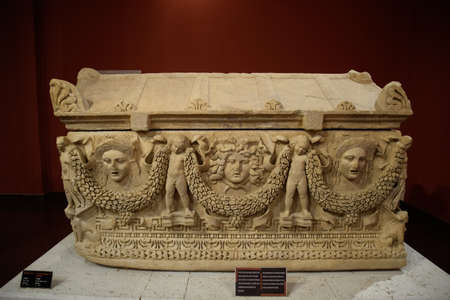 Antalya, Turkey - May 20, 2019: Marble sarcophagus. Sarcophagi from the excavations of the city of Perge. Scenes and symbols carved in the bas-relief on the walls of the sarcophagus. Museum of antiquity of Antalya.のeditorial素材