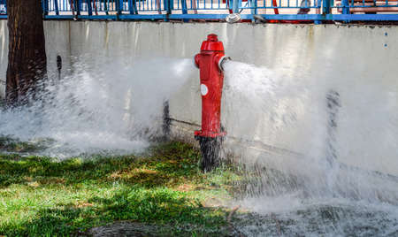 Open fire hydrant, water flows from a fire hydrantの写真素材