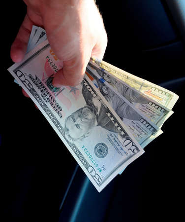 Hand transmitter dollars. Transferring money out of the hands. American dollars in a hand.