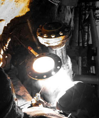 Safety at work. Welding and grinding of iron constructions. Industrial weekdays welders and fitters.