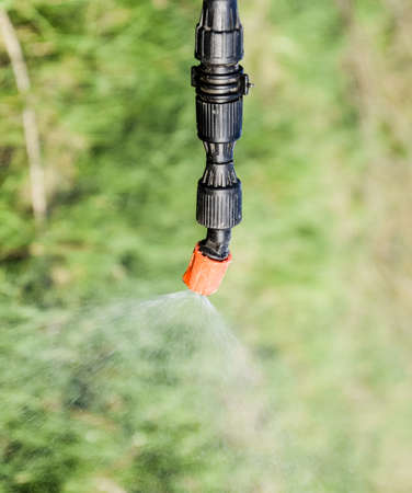 Spraying herbicide from the nozzle of the sprayer manual. Devices for processing plants in the...