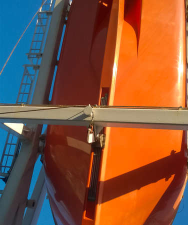 A lifeboat in case of an accident in the port or on a ship. The orange boat.の写真素材