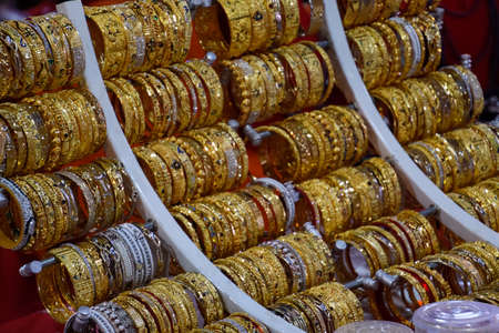 Indian rings and bracelets in silver and gold and jewelry on the counter in the store.