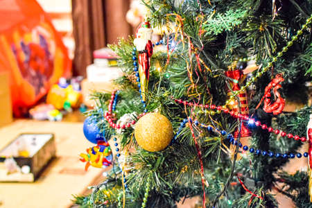 Childrens toys on the floor against the background of the Christmas tree