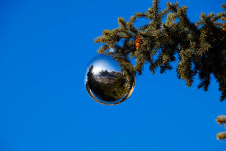 Tinsel and toys, balls and other decorations on the Christmas Christmas tree standing in the open air. Decorations New Year tree.の写真素材