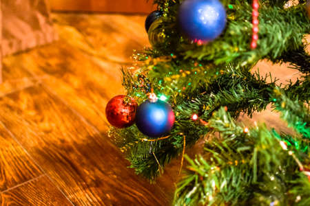 Tinsel and toys, balls and other decorations on the Christmas Christmas tree standing in the open...
