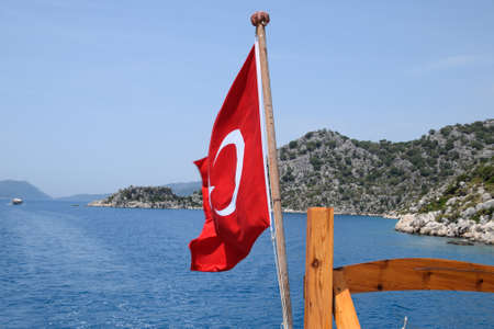 Turkey flag at the stern of a pleasure yacht. View of the Mediterranean coastの写真素材