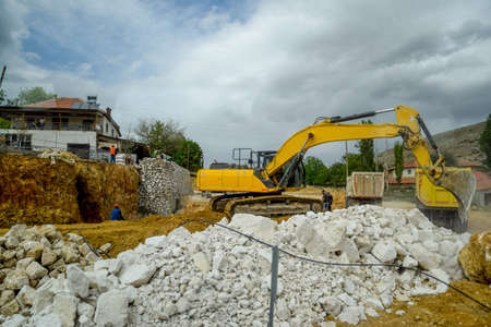 Excavator work at a construction site. Excavator digs a hole.