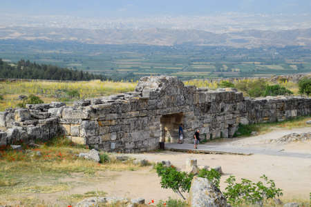 Pamukkale, Hierapolis, Turkey - May 22, 2019: Tour groups on the ruins of Hierapolis. Tourists are shown the ruins of the ancient city.のeditorial素材