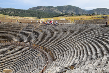Pamukkale, Hierapolis, Turkey - May 22, 2019: Ancient antique amphitheater in the city of Hierapolis in Turkey. Steps and antique statues with columns in the amphitheaterのeditorial素材