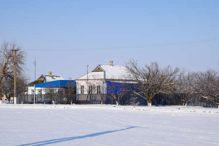 Village house in a Russian village in winter. The house is in the snow.の写真素材