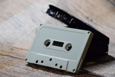 audio cassette. Retro music medium, compact cassette for tape recorder. Retro audio cassettes next to a portable player to play compact cassettes.の写真素材