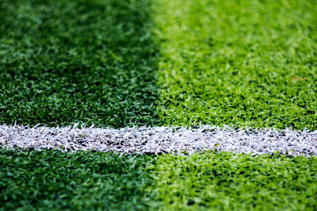 The white Line marking on the artificial green grass soccer fieldの写真素材