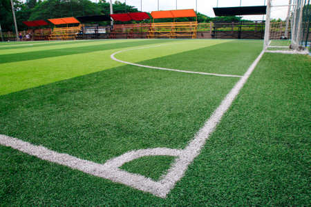 Photo of a green synthetic grass sports field with white line shot from above