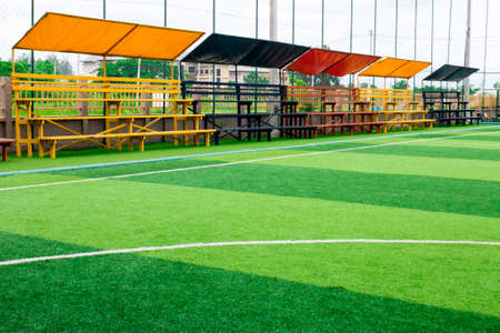 Photo of a green synthetic grass sports field with white line shot from above