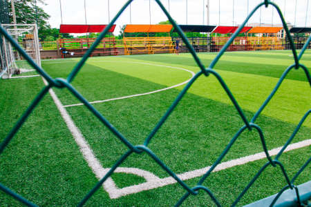 Photo of a green synthetic grass sports field with white line shot from aboveの写真素材