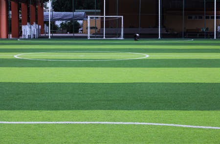 Photo of a green synthetic grass sports field with white line shot from above