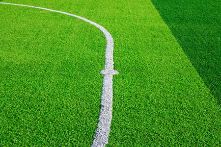 Photo of a green synthetic grass sports field with white line shot from aboveの写真素材