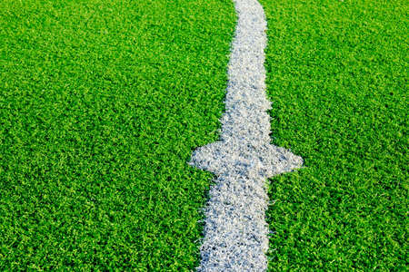 Photo of a green synthetic grass sports field with white line shot from above