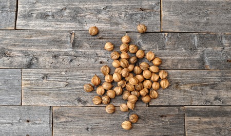Assortment of nuts on wooden old table,healthy vegan food.