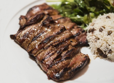 Grilled steak served with rice and green leaf saladの写真素材