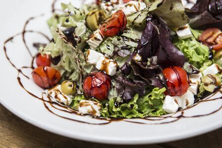 Greek salad with fresh vegetables, feta cheese and black olives