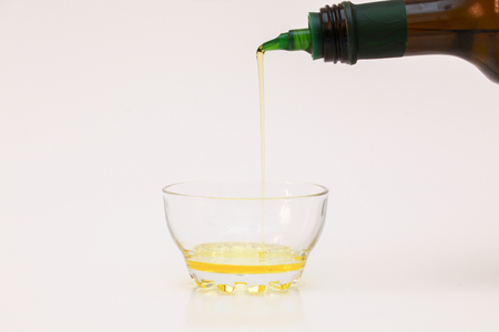 olive oil with green bottle pouringの写真素材