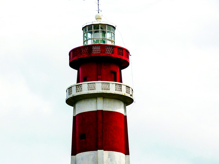 Red and white lighthouse,standing out against a neutral background......の写真素材