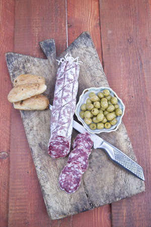antipasto of salami and olives basedの写真素材