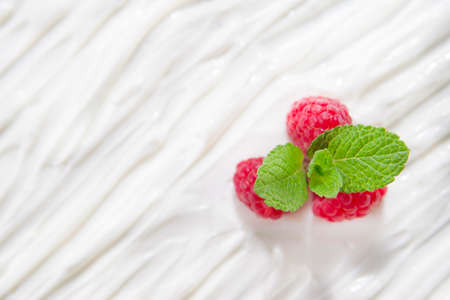 Bed Of Yogurt With Raspberry Buds And Leaves Of Mintの写真素材