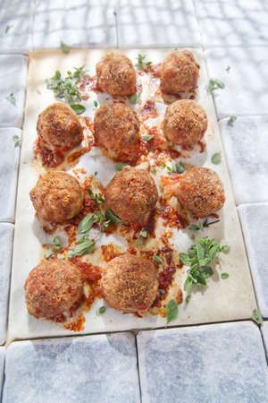 According plate of meatballs and baked potatoesの写真素材